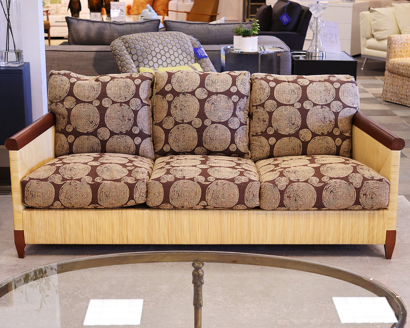 Donghia Bamboo sofa with brown and tan circular patterned fabric.  Bamboo frame