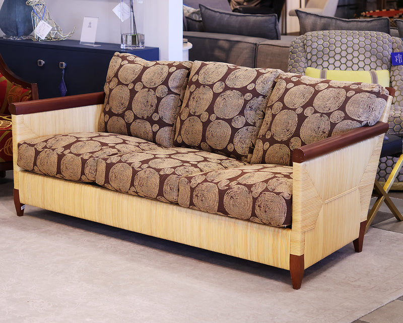 Donghia Bamboo sofa with brown and tan circular patterned fabric.  Bamboo frame